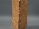an old book sitting on top of a table next to a gray background