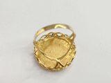 a close up of a gold ring on a white surface