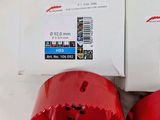 pair of red bi - metal holesaws in boxes on a white surface