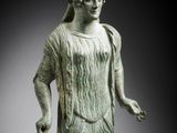 a statue of a woman in a dress and headband