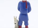 figurine of a man with a dog on a black base