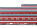 several red and black train cars sitting next to each other on a white surface