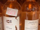 several bottles of wine are lined up on a shelf in a store