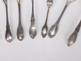 a lot of silver spoons and forks on the table