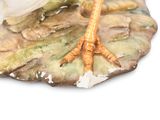 porcelain figurine of a bird on a leaf on a white background