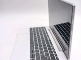 a white laptop with a black keyboard on a white surface