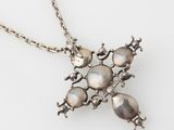 an image of a silver necklace with a star design on it