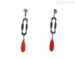 a pair of red and black earrings on a white background