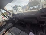 a truck that is driving down the street with a truck behind it