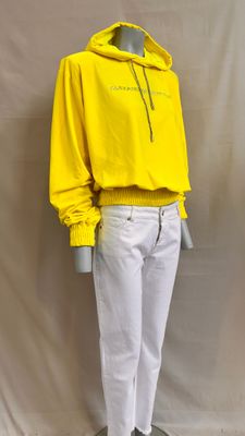 a mannequin mannequin wearing a yellow hoodie and white pants