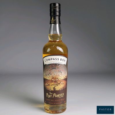 the bottle of rum monster is sitting on a white surface