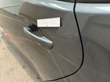 a close up of a car door handle with a sticker on it