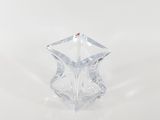 clear glass vase with a red dot on top on a white surface