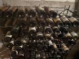 many bottles of wine that are stacked on a rack