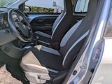 the interior of a small car with black and white seats