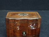 an old wooden box sitting on top of a black surface