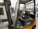 a fork lift truck with a door open in a warehouse