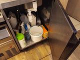 a kitchen with a stainless steel sink and a microwave
