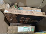 a cardboard box full of boxes and a pair of scissors
