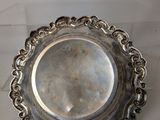 a silver plate on a table with a white background