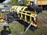 a large yellow machine that is parked in the grass