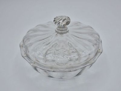 an image of a glass covered dish on a white surface