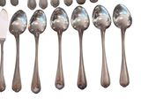 a lot of spoons and forks that are on the table