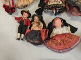 a lot of dolls that are sitting on a table