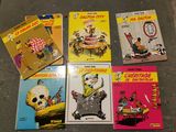 several children ' s books are lined up on a table