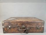 an old suitcase sitting on a white surface