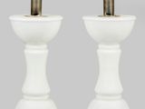 une paire de lampes de table blanches sur des socles, avec une ampoule au milieu