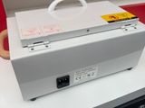 a white box with a handle on top of a counter