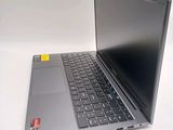 a laptop computer sitting on a table with a yellow sticker on the keyboard
