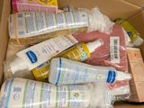 a cardboard box full of baby care items in it