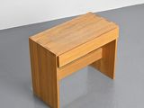 a small wooden table with a drawer on top of it