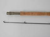 a close up of a fishing rod and a fishing rod on a white surface