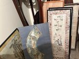 many framed maps and pictures sitting on the floor