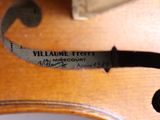a close up of a violin with a label on it