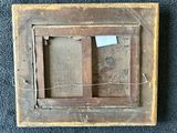 an old wooden picture frame with a picture of a man in a window