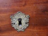 a close up of a wooden cabinet with a keyhole