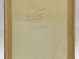 an old book with writing on it sitting on top of a table