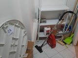 a toilet in the corner of a room with a trash can in it