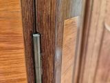a close up of a door handle on a wooden door