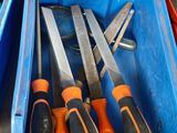 many different tools in a blue box on the table