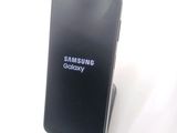 a samsung phone that is sitting on a stand