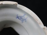 a close up of a white porcelain vase with a blue cat on it