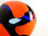 an orange and black helmet on a white surface