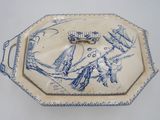 a blue and white tray with a bird design on it
