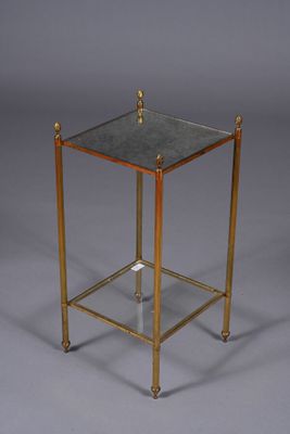 a brass and glass side table with a glass top