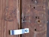 a close up of a door handle on a wooden door